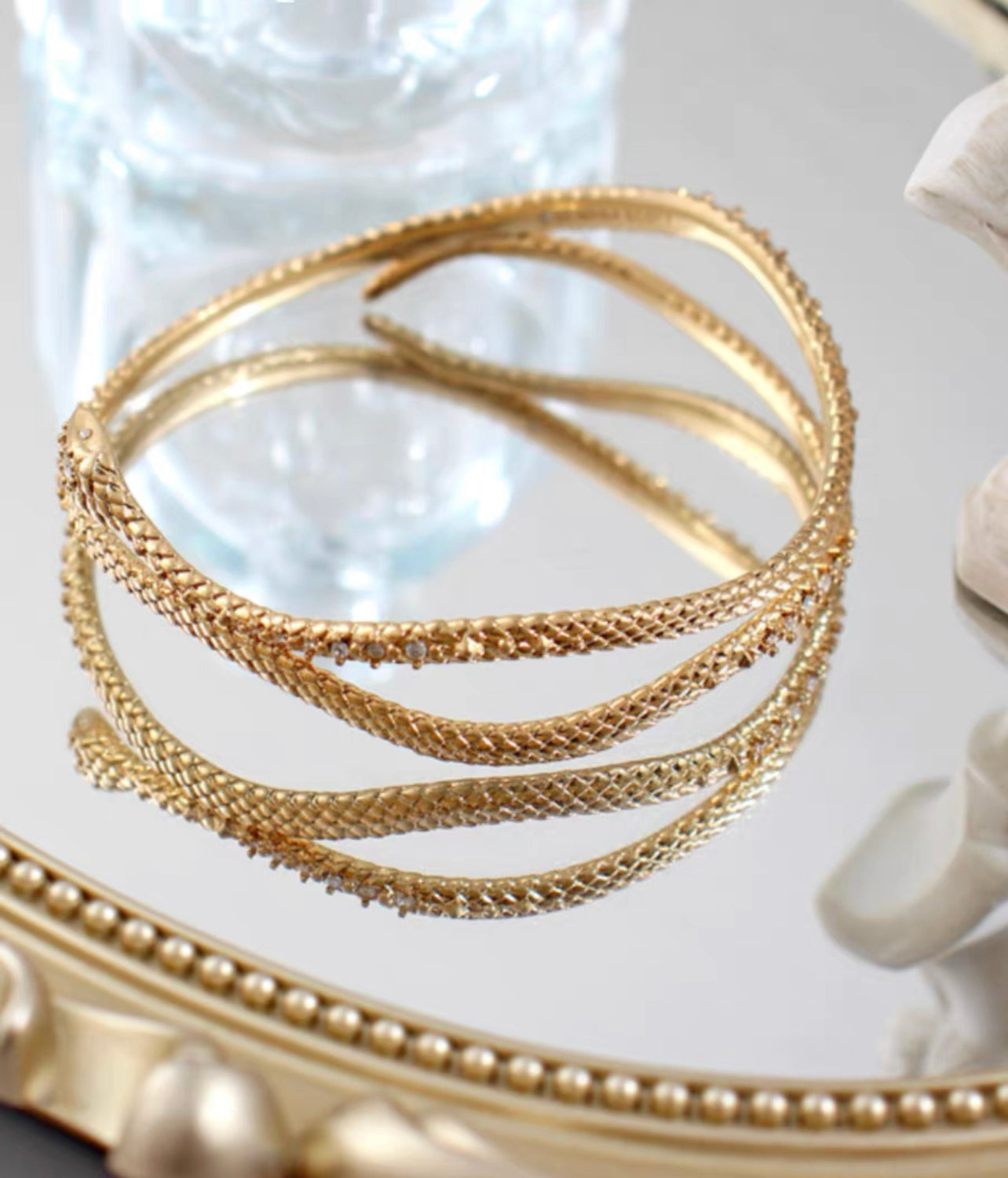 Gold snake entwined snake encrusted bracelet