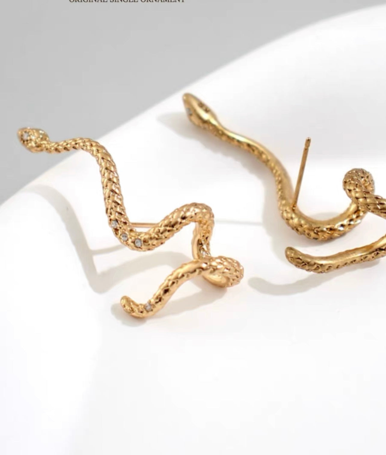 Gold snake entwined snake encrusted bracelet